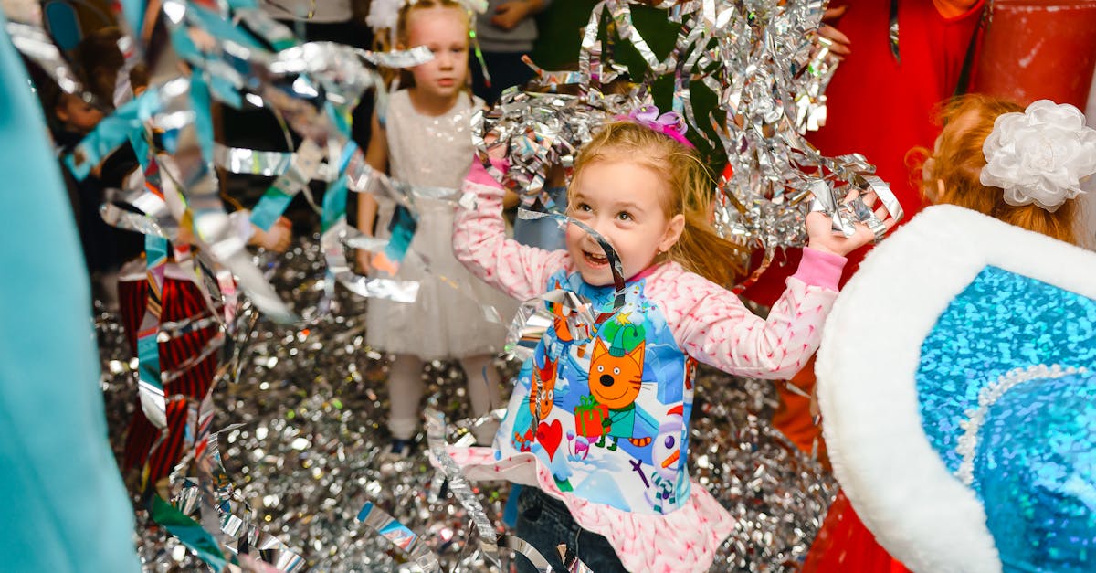 Joyful children having fun at an indoor party, with colorful streamers adding to the festive atmosphere.
