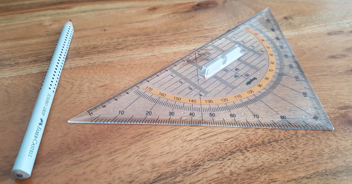 A clear triangle ruler and Faber-Castell pencil on a wooden desk, perfect for precision drawing.