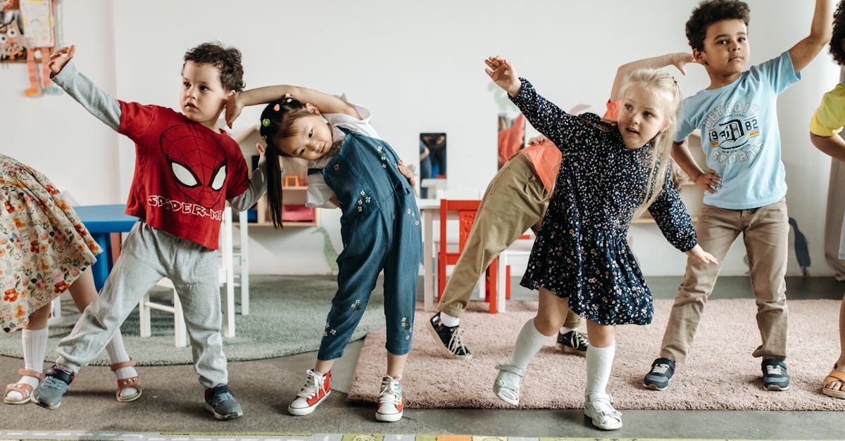 Group of diverse preschool children engaging in fun exercises indoors.