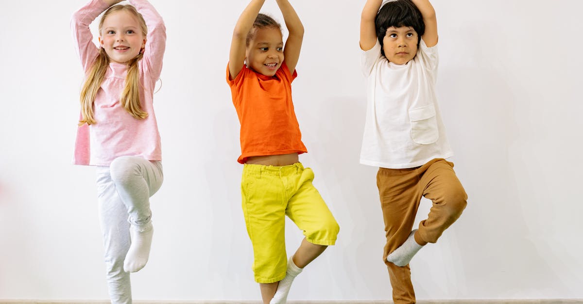 Three diverse children practicing yoga indoors, showcasing joy and balance.
