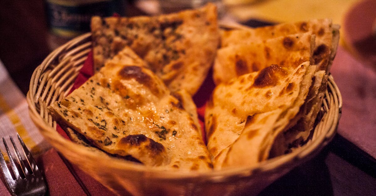 Close-up of traditional Indian flatbreads in a basket, perfect for a delicious meal.