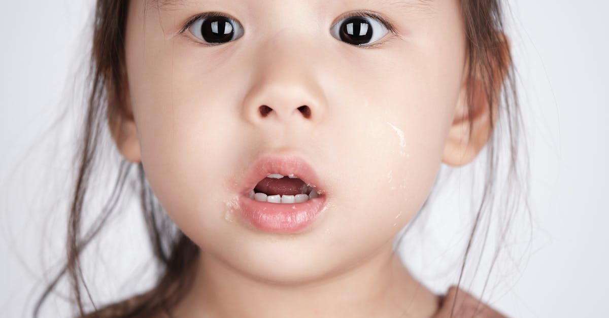 Close-up portrait of a charming young child with an expressive surprised look indoors.